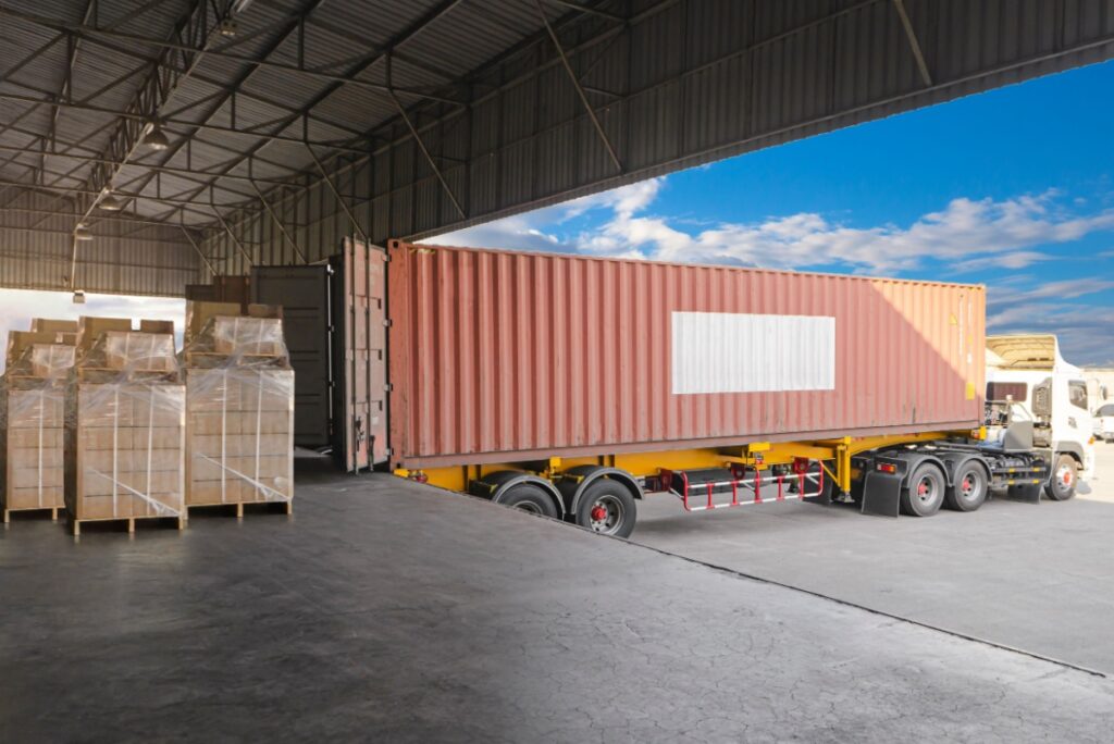 Staging area showing shrink wrapped palletized freight that was delivered from a tractor trailer driver